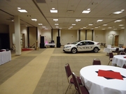 Image of a red car in a conference hall.
